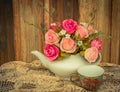 Flower in a white tea pot and vintage , cozy home rustic decor, Royalty Free Stock Photo