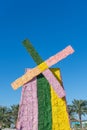 A flower windmill colored in pink, green and yellow on a blue sky sunny day at a celebration outdoors. Dutch or Netherlands theme Royalty Free Stock Photo