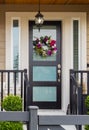 Flower wreath. Spring decoration on the door of the house. Exteriror of a house. Entrance of a nice single family house