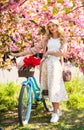 This flower is yours. flower shop. girl flower seller with retro bike. vintage bicycle for walk in park. fashion woman Royalty Free Stock Photo