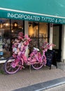 Flowered bicycle near the tatoo salon in the city of Amsterdam Royalty Free Stock Photo