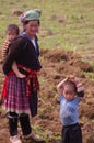 Flowered Hmong grandmother and her grand children