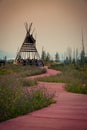 Flowered red clay walkway leads to a beautiful metal teepee at the Blackfeet Indian Memorial in Babb, Montana