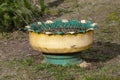 A flowerpot made of old car tires and rim