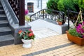Flowerpots with flowers at the staircase of the front porch of the building. Royalty Free Stock Photo