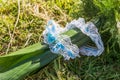 Blue and white lace garter rolled up in a bridal bouquet. Royalty Free Stock Photo