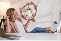 Flowers as a gift, Flower delivery. A young woman with a beautiful bouquet of peonies