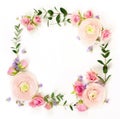 Flowers background. Flowers wreath frame from pink flowers roses and ranunkulus, eucalyptus branshes Royalty Free Stock Photo