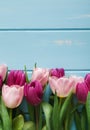 Flowers background, Violet and pink tulips on blue wood, copy space Royalty Free Stock Photo