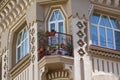 Flowers on the balcony of the building in the classical style