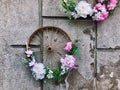 Flowers in bicycles wheel on the wall at the street of Przemysl