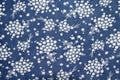 Flowers on blue fabric pattern background Royalty Free Stock Photo