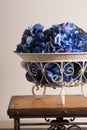 Flowers of blue hydrangeas in a metal florid forged vase