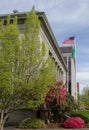 Flowers and blue sky surround a government building in Washington State.