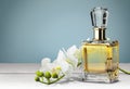 Perfume bottle and flowers isolated on background Royalty Free Stock Photo