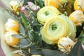 Flowers in bouquet close-up. yellow Ranunculus and tulips, eucalyptus leaves