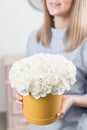 Flowers bouquet in yellow headbox. Young happy woman holding a beautiful bunch of white carnation. Present for a smiles Royalty Free Stock Photo