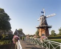 Flowers on bridge and old windmill in dutch town of dokkum Royalty Free Stock Photo