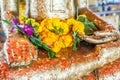 Flowers on buddha statue`s lap Royalty Free Stock Photo