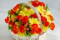 Flowers bunch wicker basket, with red roses and yellow chrysanthemums in gift box Royalty Free Stock Photo