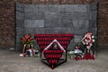 Flowers and candles by the Wall of Death, Auschwitz