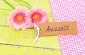 Flowers and card with german word, Auszeit, means timeout or relax at Spa or Wellness treatment therapy Royalty Free Stock Photo