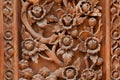 Flowers carved on a wooden board of ancient door Royalty Free Stock Photo