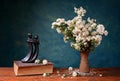 Flowers in a ceramic vase and metal figure