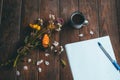 Flowers, coffee, paper and pen on the table Royalty Free Stock Photo