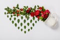 Creative layout made of coffee or tea cup with red roses on white background Royalty Free Stock Photo