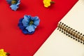 Flowers composition, flat design, blank notebook with place for text on a red background, top view close up Royalty Free Stock Photo