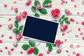 Flowers composition. frame made of pink rose flowers with blank photo frame Royalty Free Stock Photo