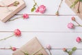 Flowers composition. Gifts and rose flowers on white wooden table. Women Day. Flat lay, top view