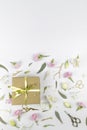 Flowers composition. Gifts and rose flowers on white wooden table. Women Day. Flat lay, top view, copy space Royalty Free Stock Photo