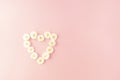 Flowers composition. heart frame made of white small rose on pink background. Mother's day, Valentine's day Royalty Free Stock Photo