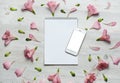 Flowers composition. Notebook and telephone with pink flowers and leaves. Top view, flat lay Royalty Free Stock Photo