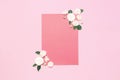 Flowers composition. Pink blank paper, white fresh roses and green leaves on gentle pink background. Flat lay, top view, copy Royalty Free Stock Photo