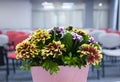 Flowers composition on table in empty conference room, office Royalty Free Stock Photo
