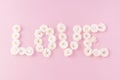 Flowers composition. The word LOVE is made of small white roses on a pink background,. Mother's day, Valentine's Royalty Free Stock Photo