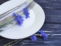 Flowers cornflowers menu catering arrangement summer , plate, fork knife on a wooden background