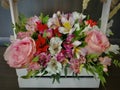 Flowers cute bouquet with roses and alstroemerias pink white green, wooden box