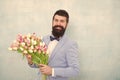 Flowers delivery. Gentleman romantic date. Birthday greetings. Best flowers for girlfriend. Flowers for her. Man bearded Royalty Free Stock Photo