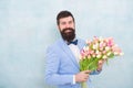 Flowers delivery. Gentleman romantic date. Birthday greetings. Best flowers for girlfriend. Flowers for her. Man bearded Royalty Free Stock Photo