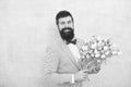 Flowers delivery. Gentleman romantic date. Birthday greetings. Best flowers for girlfriend. Flowers for her. Man bearded Royalty Free Stock Photo