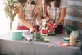 Flowers delivery top view. Florists creating order, making rose bouquet in flower shop. Two female florists are doing Royalty Free Stock Photo