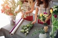 Flowers delivery top view. Florists creating order, making rose bouquet in flower shop. Two female florists are doing Royalty Free Stock Photo
