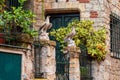 Flowers and eagle sculptures on entrance gate of old buildings on Montmartre, Paris. Autumn in France, old town. Royalty Free Stock Photo