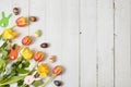 Flowers, Easter eggs and bunnies on a white wooden table. Royalty Free Stock Photo