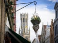 Flowers in front of the Belfry of Bruges on a sunny day in summer