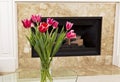 Flowers in front of fire place Royalty Free Stock Photo